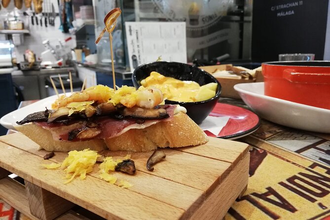 Wine and Tapas walking Tour in Malaga - First stop: traditional tapas and Malaga food culture